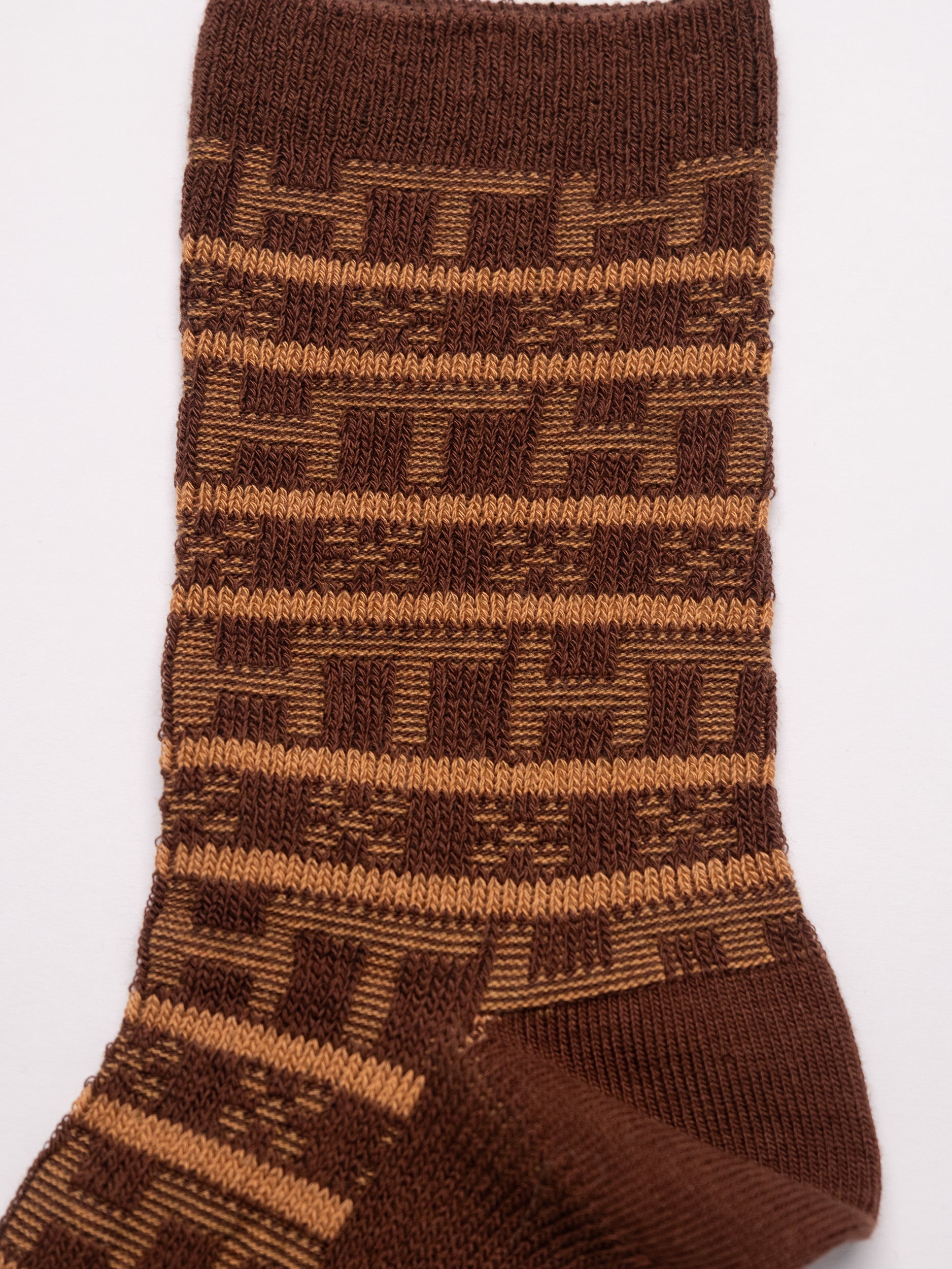 Brown patterned sock on a white background