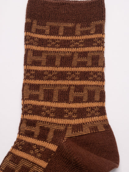 Brown patterned sock on a white background