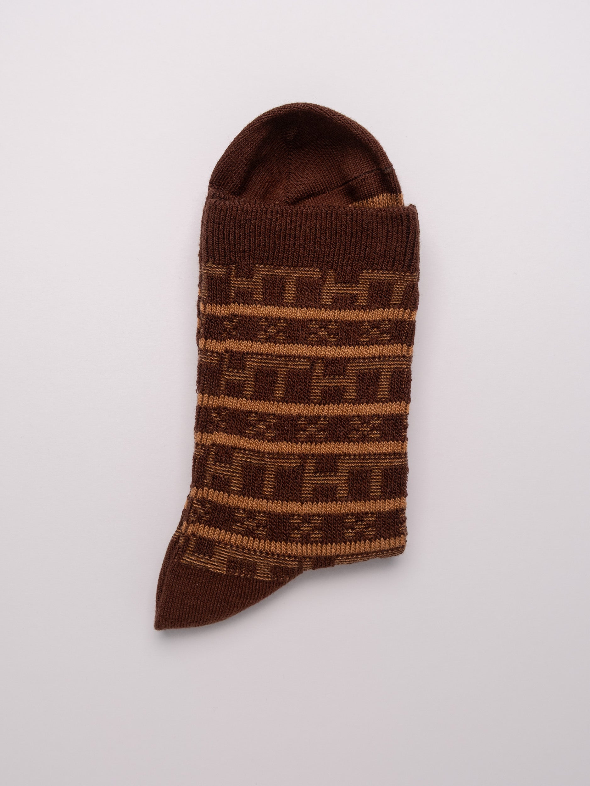 Brown patterned sock on a light gray background