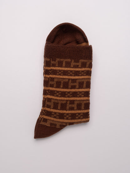 Brown patterned sock on a light gray background