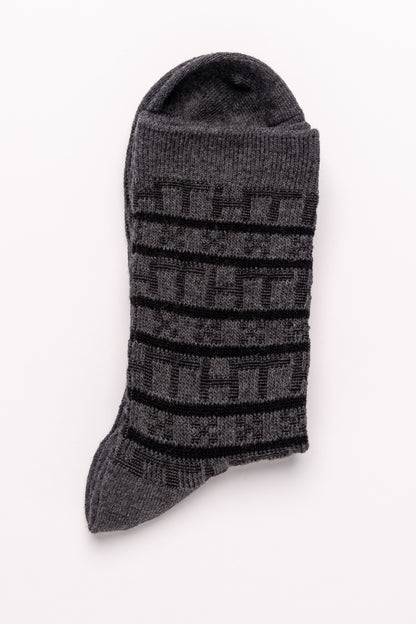 Gray sock with black pattern on a white background