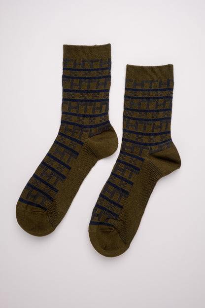 Pair of green socks with black text on a white background