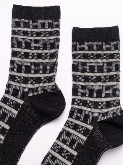 Pair of black and gray patterned socks on a white background