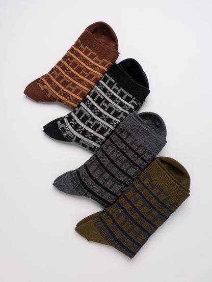Four pairs of patterned socks in brown, black, gray, and green on a white background.