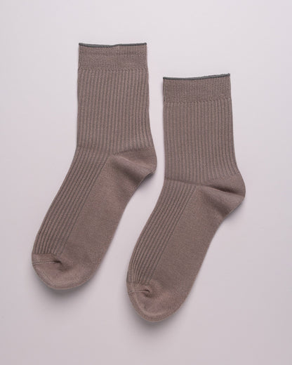 Pair of brown socks on a light gray background
