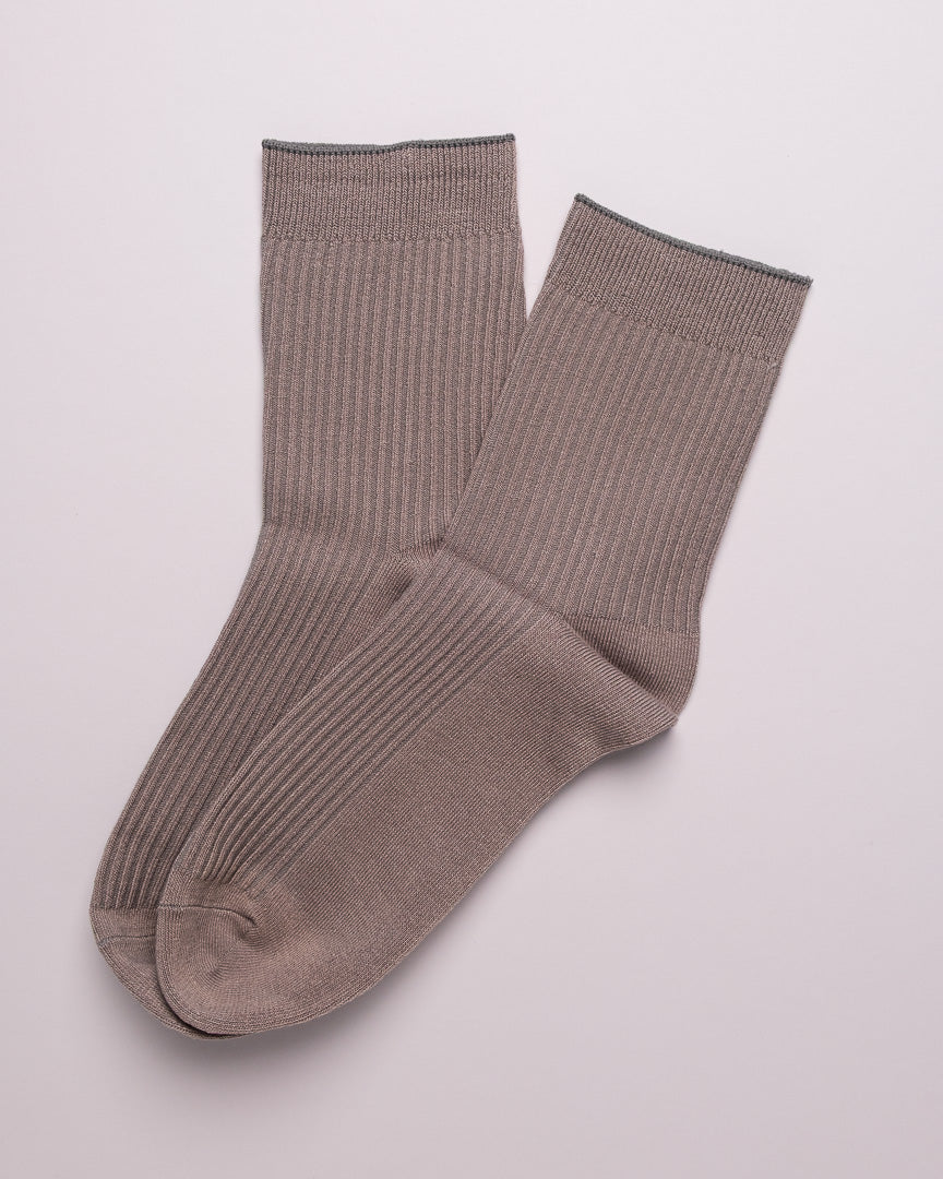 Pair of brown ribbed socks on a light gray background