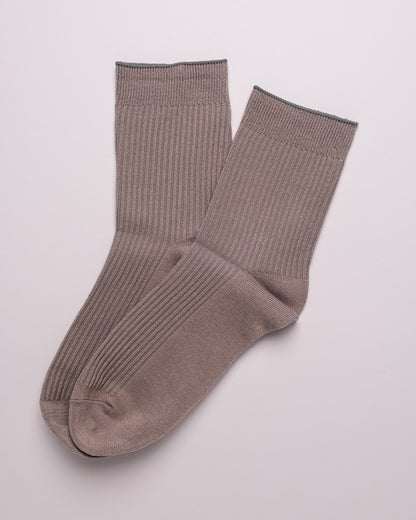 Pair of brown ribbed socks on a light gray background