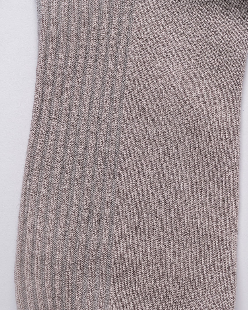 Close-up of a gray sock with ribbed texture on a white background