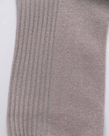 Close-up of a gray sock with ribbed texture on a white background