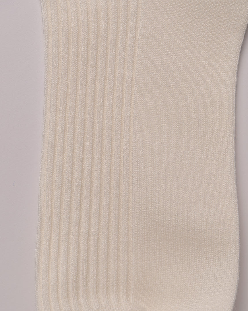 Close-up of beige ribbed fabric on a light purple background