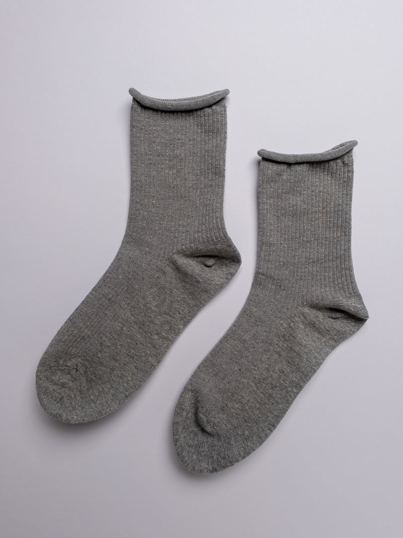 Pair of gray socks on a light gray background