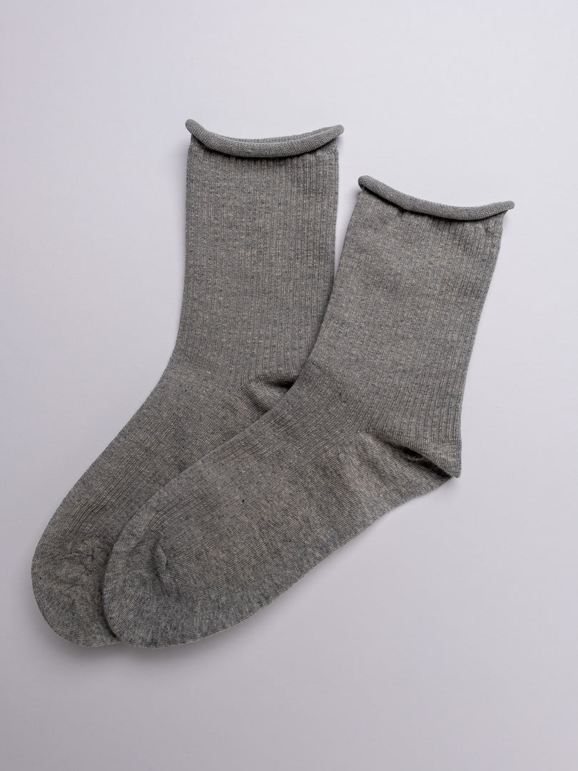 Pair of gray socks on a light gray background
