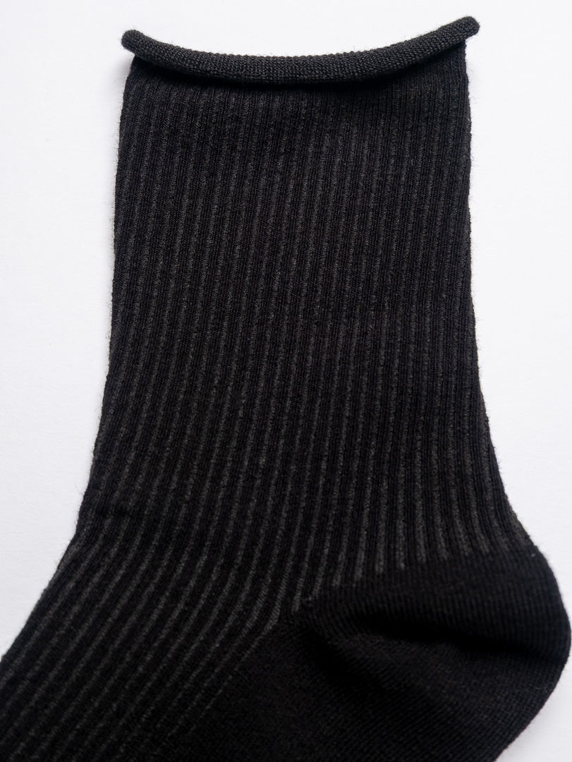 Black ribbed sock on a white background