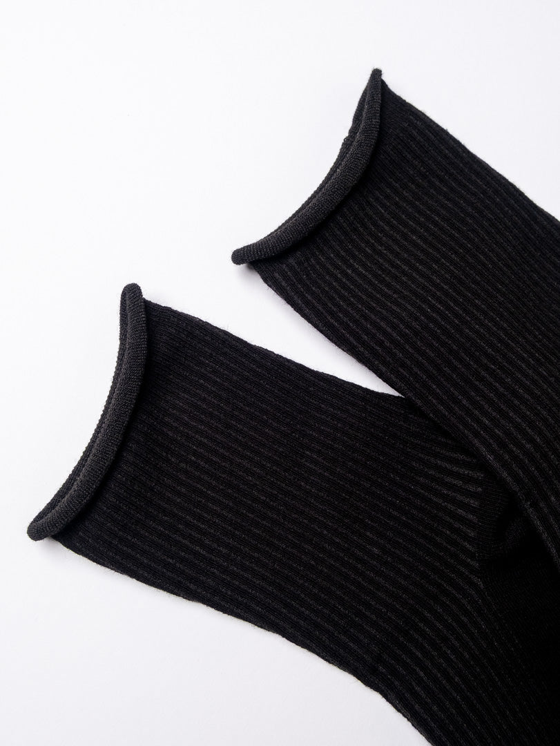 Pair of black ribbed socks on a white background
