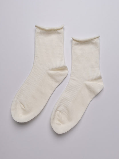 Pair of white socks on a light gray background