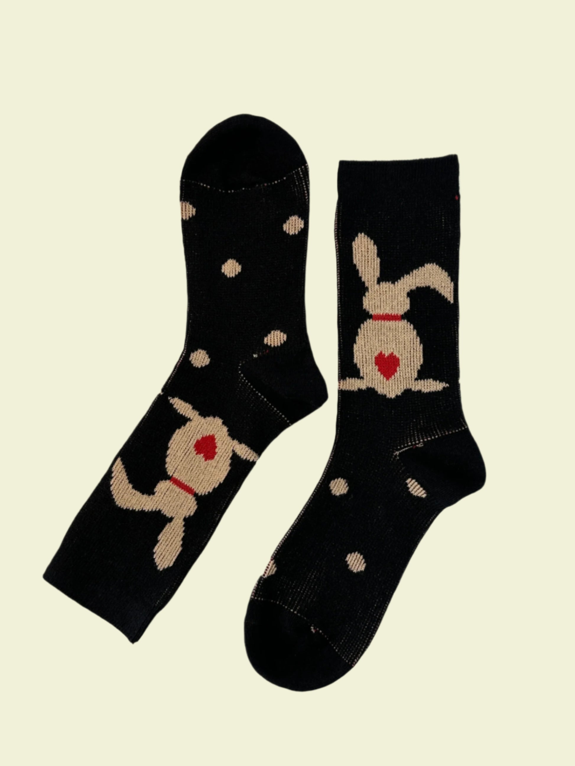 Pair of black socks with cartoon dog design on a white background