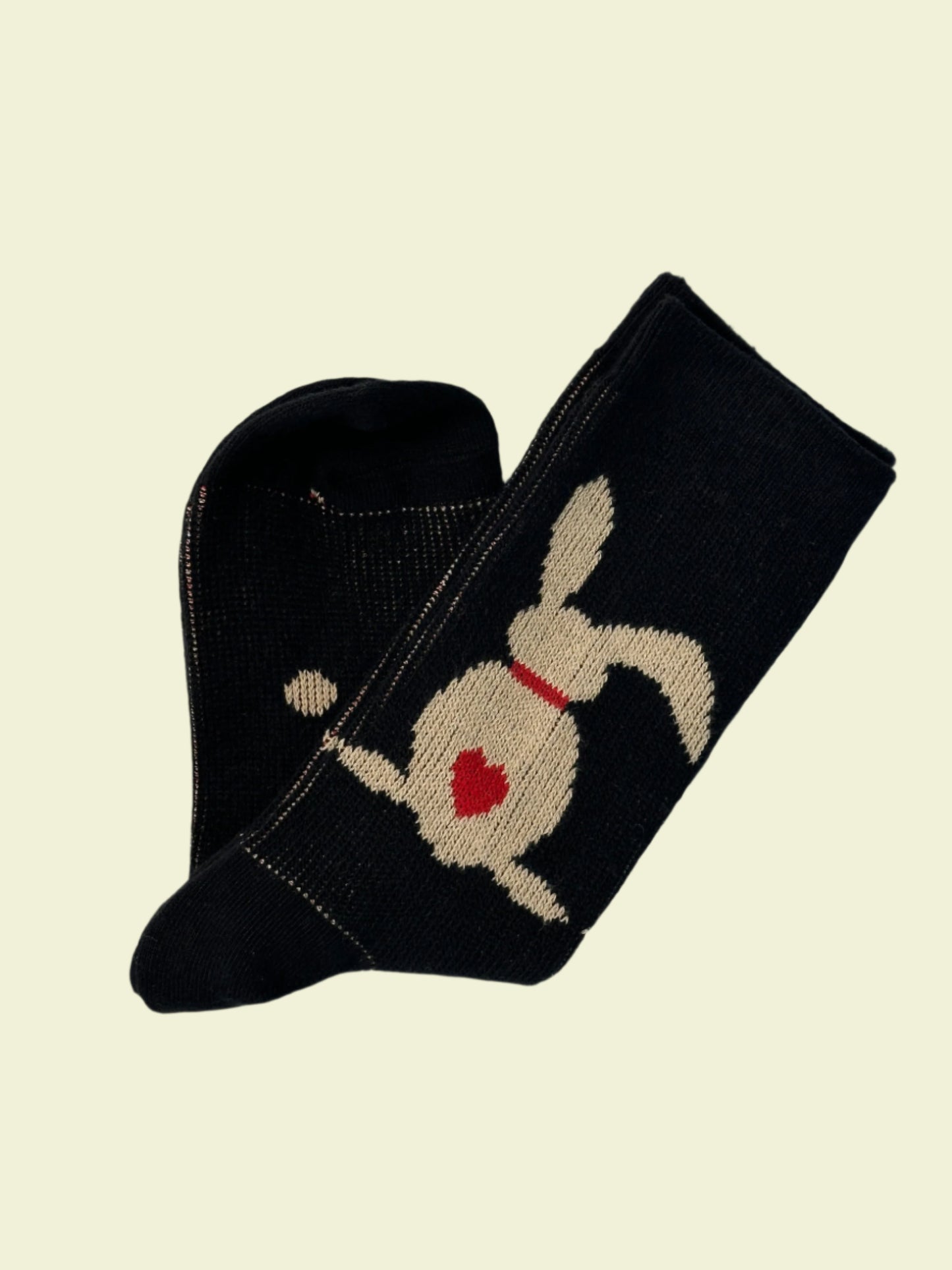 Black sock with a white dog design on a light gray background
